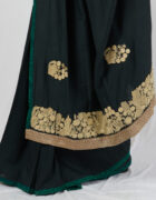 Black soft tussar sari with hand embroidered thread butas and a broad border at the pallu