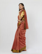 Rust zari chex chanderi sari with green tissue border at the skirt and gold zardozi detail at the shoulder and pallu