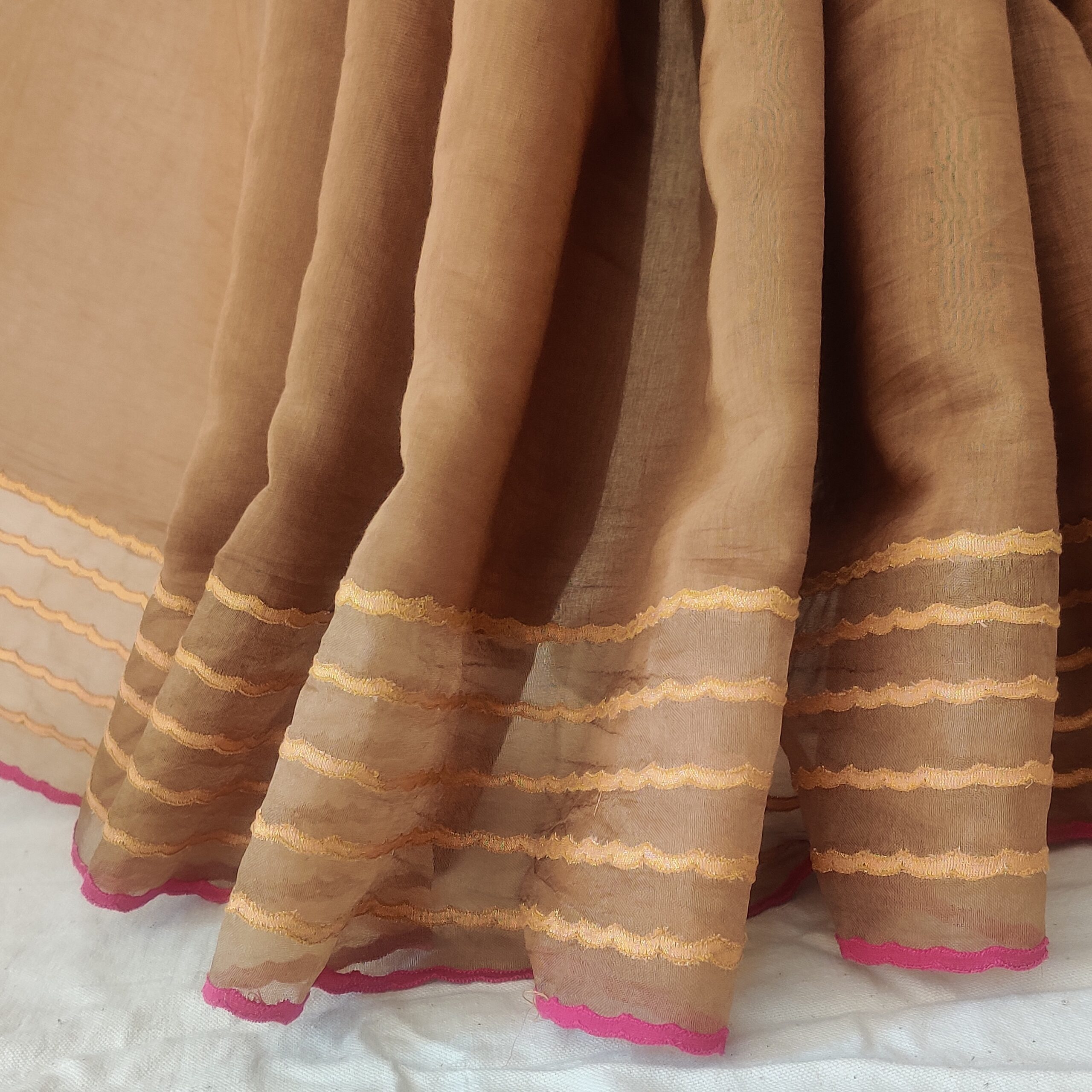 The first half being chanderi tissue striped and second half is organza chikankari embroidered with mukesh highlighted with dori and gota embroidered border
