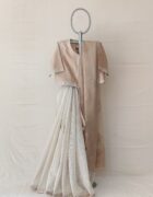 The first half being chanderi tissue striped and second half is organza chikankari embroidered with mukesh highlighted with dori and gota embroidered border.