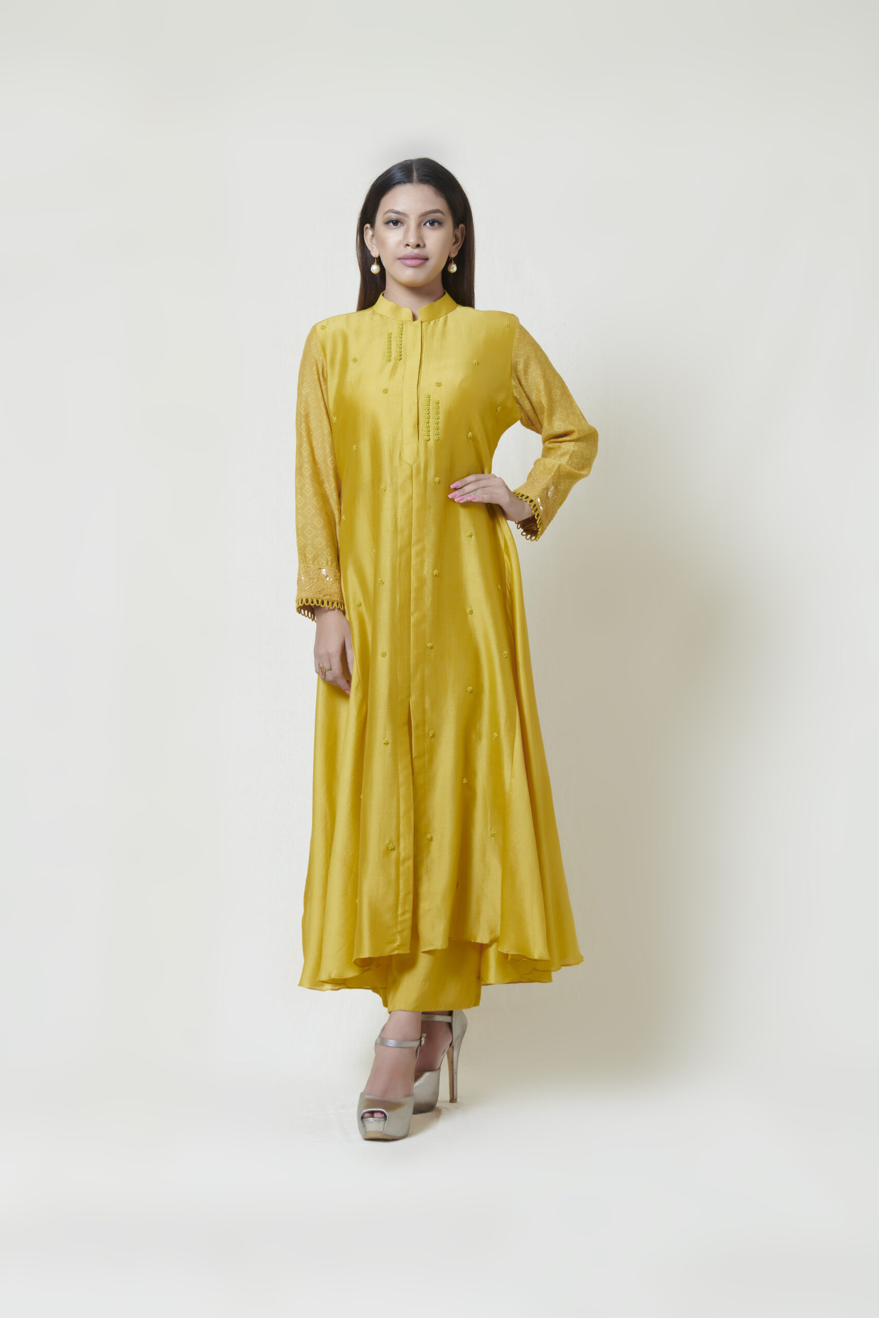 Golden yellow full sleeved centre slit kurta in chanderi with french knot and spring thread hand embroidery highlighted with glass beads. It comes along with a pair of pants