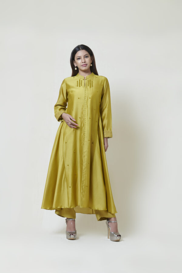 Dark olive kurta in chanderi with french knot hand embroidery accentuated with chikankari embroidered cuffs. It comes along with a pair of pants
