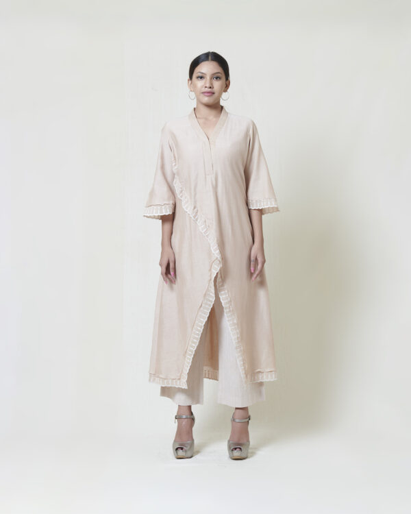 Kora chanderi kurta layered in mulmul accentuated with ivory fabric applique and cutwork detailing adorned with thread spring embroidery back buta