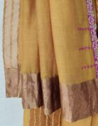 Mustard yellow kora chanderi sari with an Organza border with tissue applique and hand thread embroidery details