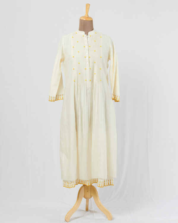 Ivory dress layered in mulmul with applique and cutwork detail
