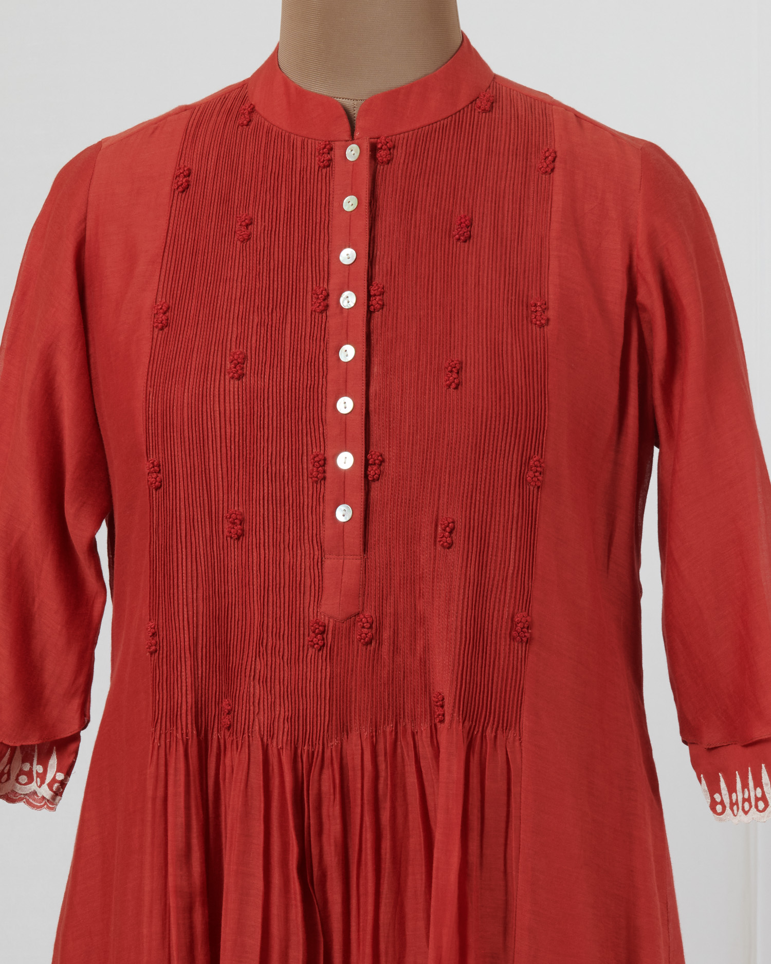 Chilli red dress layered in mulmul with applique and cutwork detail