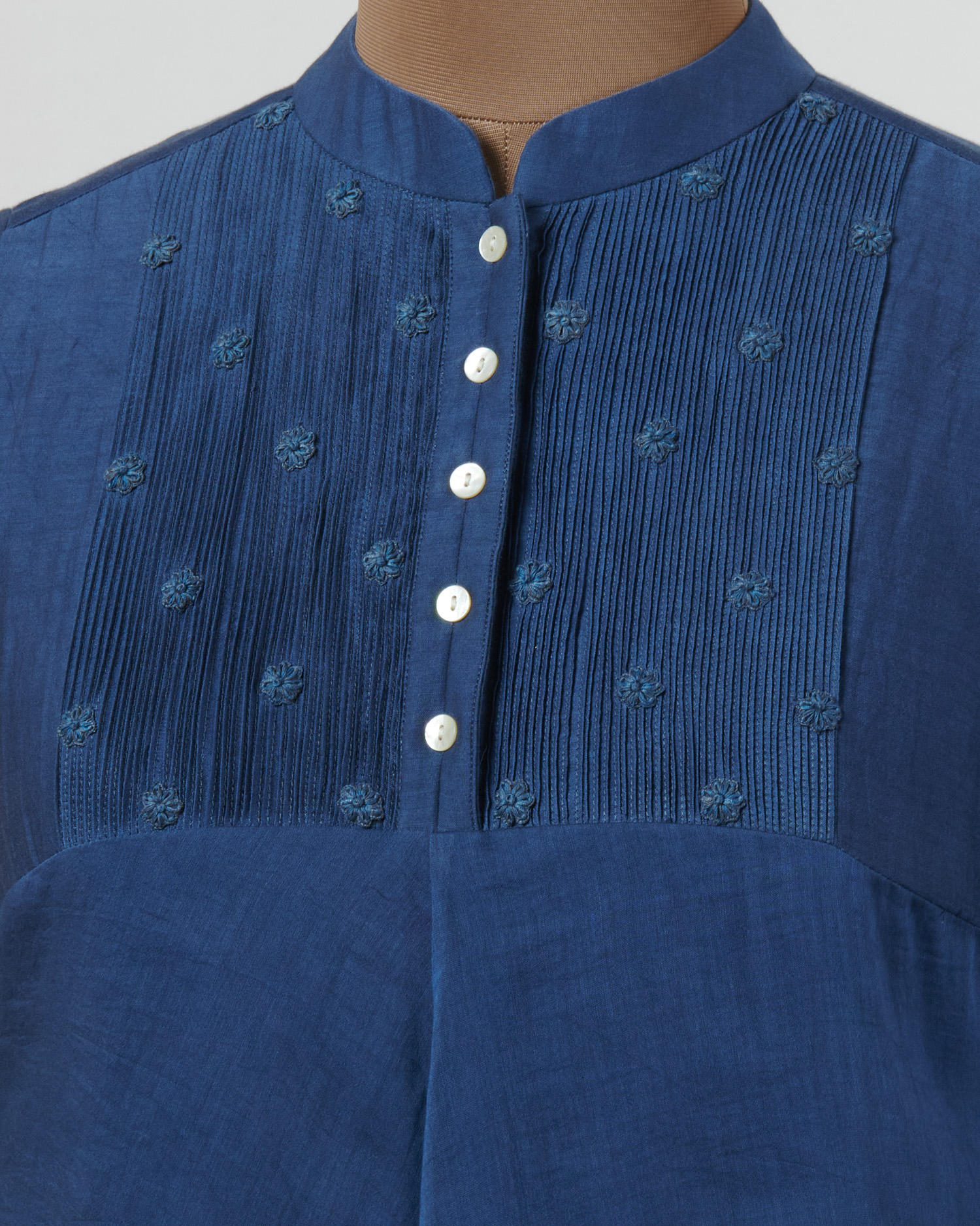 Indigo blue asymmetric dress layered in mulmul with applique and cutwork detail