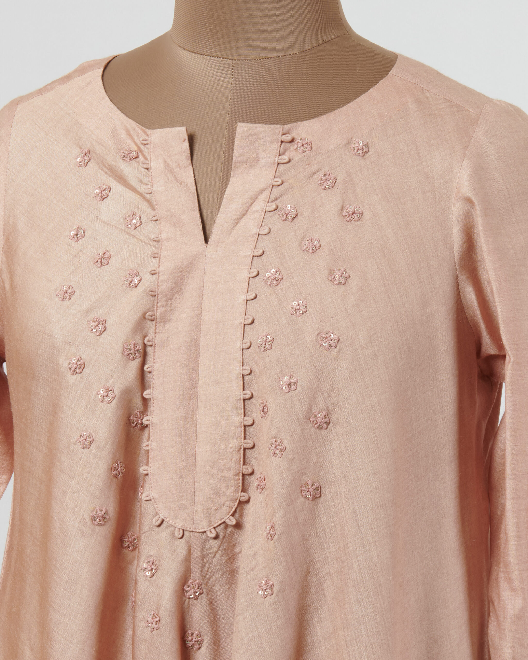 Tunic with thread embroidered butis at the yoke and highlighted with silver kanchi tissue applique and cutwork at hemline