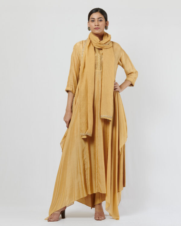Light olive mul silk long tunic with asymmetric hemline, paired with matching drape pants. It is teamed with a zardozi embroidered kota dupatta