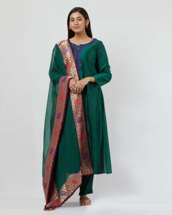 Bottle green kurta with purple thread hand embroidered flowers at the neckline