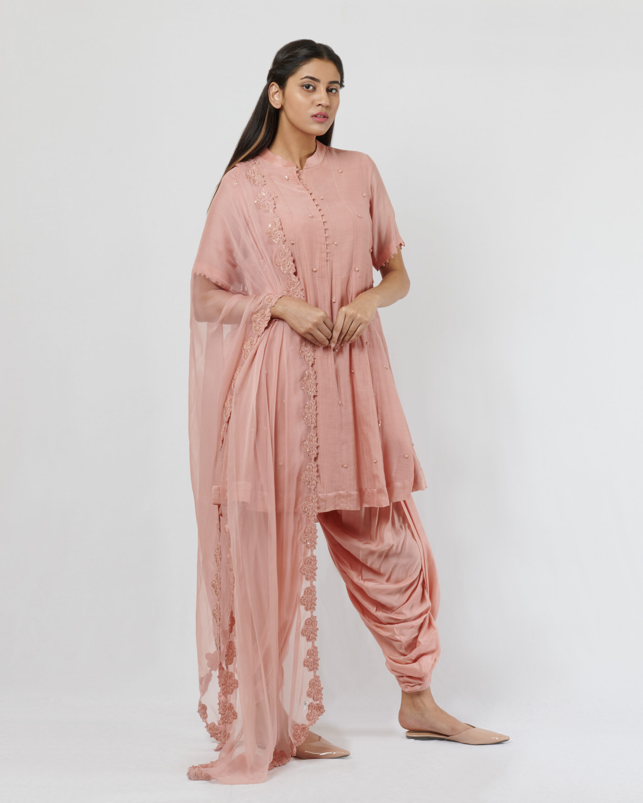 Kora chanderi short kalidar with hand crafted potlis and sequence details teamed with a chiffon hand thread embroidered dupatta. it comes along with dhoti pants