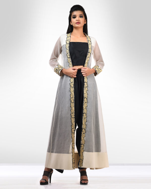 Black drape pants and blouse teamed with an ivory kota kalidar jacket adorned with beige thread hand embroidery details