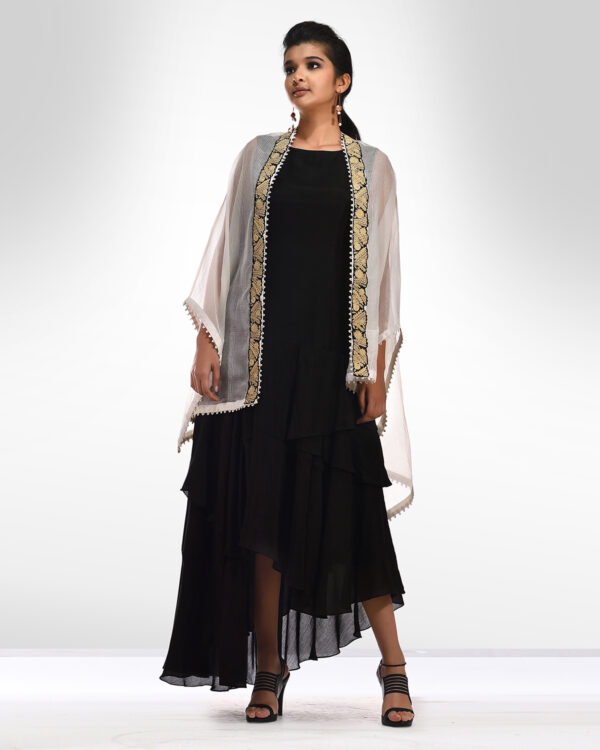 Black panels dress teamed with an ivory embroidered kota poncho