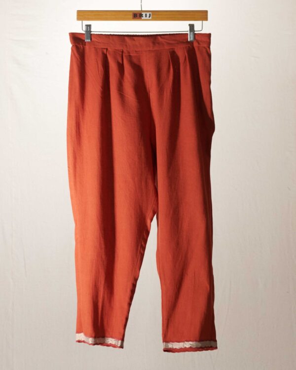 Rust pant with dull gold kanchi tissue applique hemline