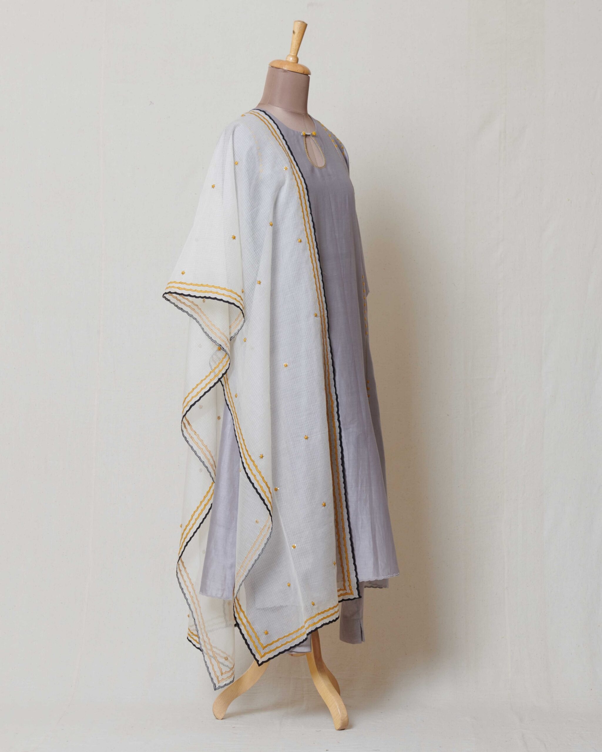 Ivory moonga kota dupatta with yellow and black applique border with yellow and dull gold butis all over