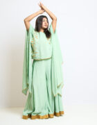 " Pastel green cape and divided skirt with gold border